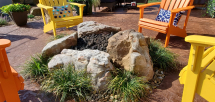 Boulder stone gas fire pit with lava rock